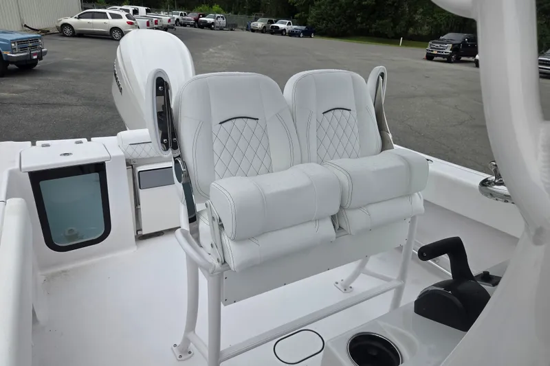 Slide: The Image of 2026 Sportsman Open 232 Center Console boat with white cushioned seating and modern controls. - 12