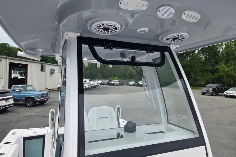 Slide: The Image of 2026 Sportsman Open 232 Center Console boat interior with speakers and windshield. - 10