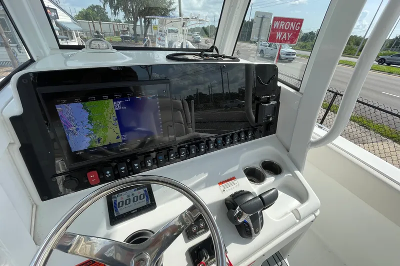 Slide: The Image of 2021 Sea Hunt Ultra 265SE boat dashboard with navigation system and controls. - 13