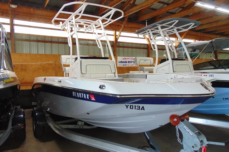 The Image of 2026 Yamaha Boats 195 FSH Sport in a showroom, featuring sleek design and modern features. - 0