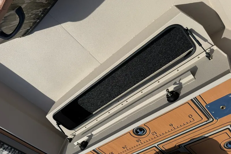 Slide: The Image of Storage compartment on a 2027 Avid 20 Rogue CC boat, featuring a sleek design. - 17