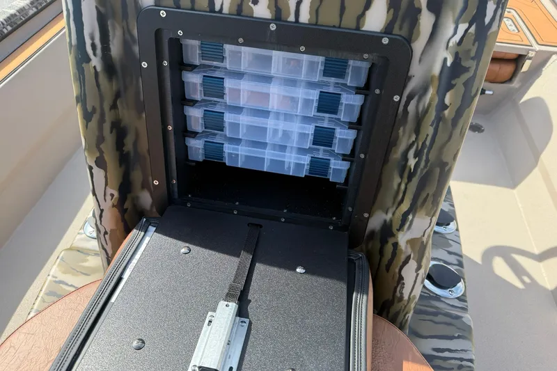 Slide: The Image of Storage compartment with tackle boxes in a 2027 Avid 20 Rogue CC boat. - 15