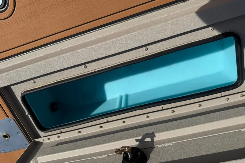 Slide: The Image of Open storage compartment on 2027 Avid 20 Rogue CC boat. - 16