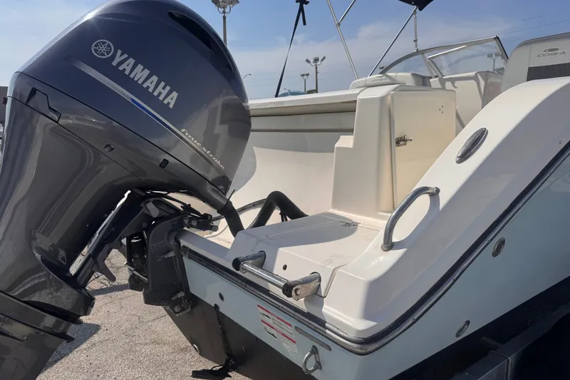 Slide: The Image of 2023 Cobia 220 Dual Console boat with Yamaha outboard motor, rear view. - 5