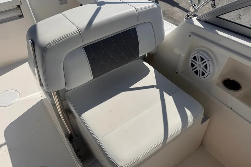 Slide: The Image of 2023 Cobia 220 Dual Console boat seat with speaker and cup holder. - 10
