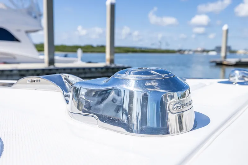 Slide: The Image of Close-up of a 2011 Everglades 295 Center Console boat's chrome detail by the water. - 50