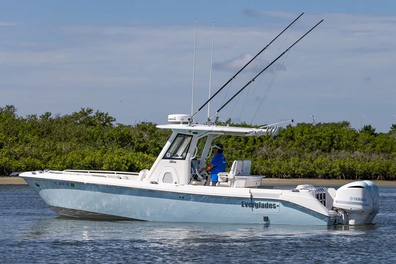Slide: The Image of 2011 Everglades 295 Center Console boat on water, featuring dual Yamaha engines. - 17