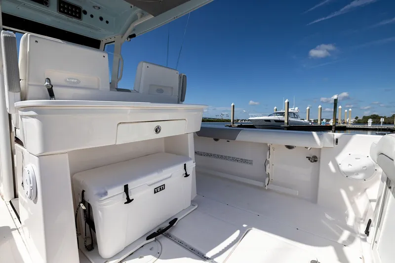 Slide: The Image of 2011 Everglades 295 Center Console boat interior with Yeti cooler and seating. - 35