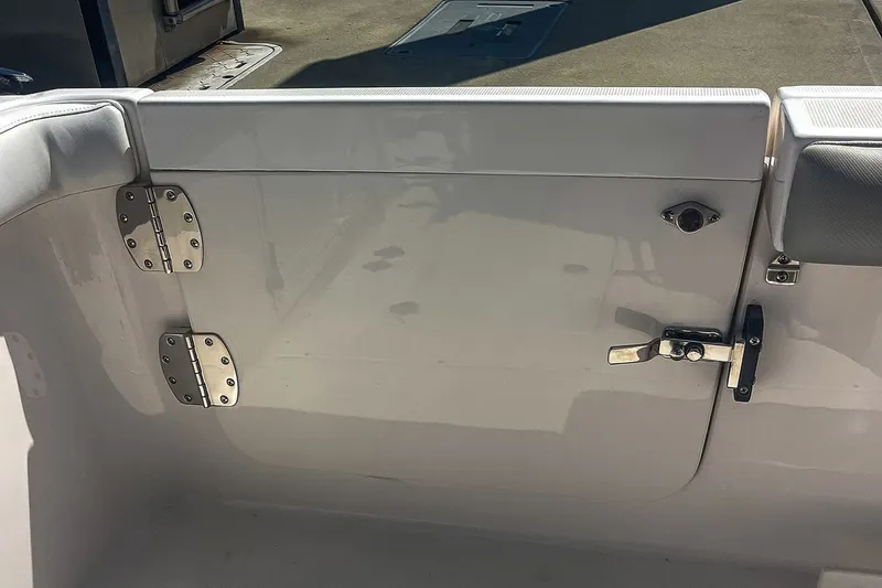Slide: The Image of 2011 Everglades 295 Center Console boat interior, featuring a sturdy door with metal hinges and latch. - 24
