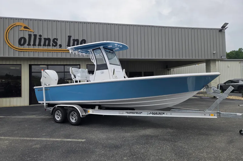 The Image of 2026 Sportsman Masters 247OE Bay Boat on trailer outside Collins, Inc. building. - 0