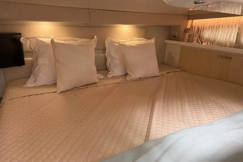 Slide: The Image of Luxurious cabin interior of 2025 Regal 33 Express yacht with cozy bedding. - 14