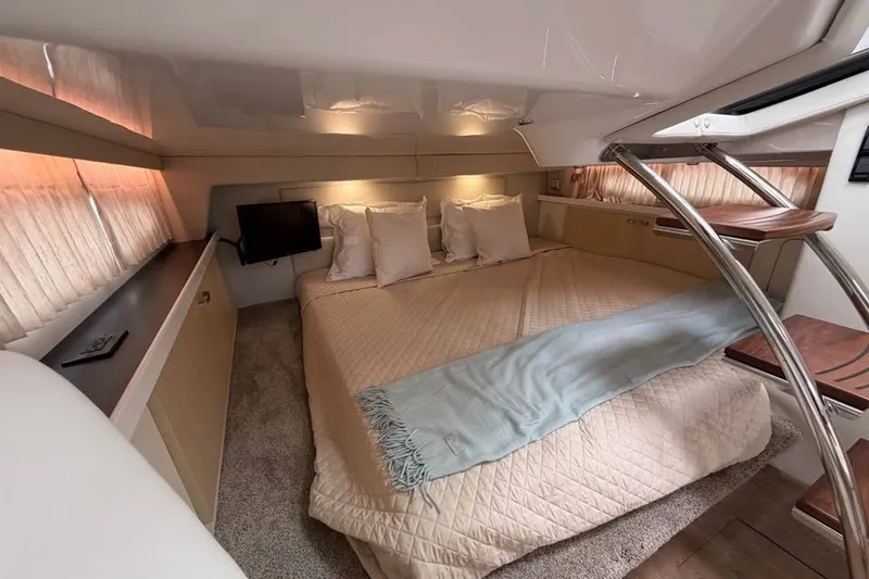 Slide: The Image of Luxurious cabin interior of 2025 Regal 33 Express yacht with cozy bedding and modern amenities. - 13