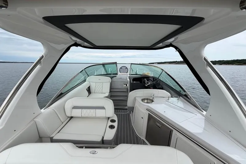 Slide: The Image of 2025 Regal 33 Express yacht interior with luxurious seating and sleek design on open water. - 9