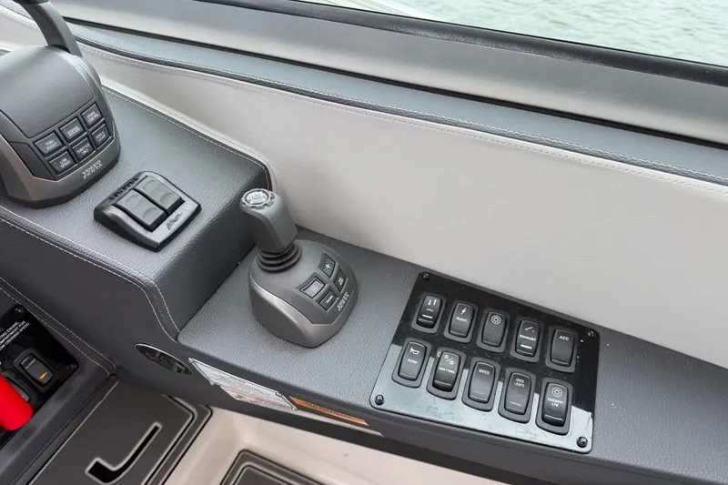 Slide: The Image of Control panel of 2025 Regal 33 Express boat with joystick and switches. - 7