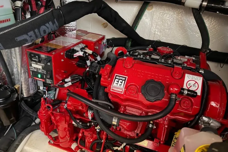 Slide: The Image of Engine compartment of 2025 Regal 33 Express boat with red multiport EFI system. - 16