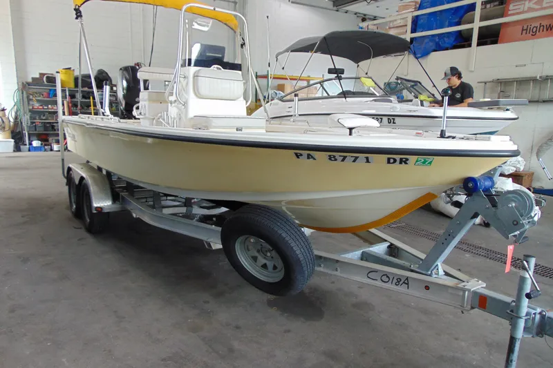 Slide: The Image of 2015 Mako 21 LTS boat on trailer in a garage setting. - 2