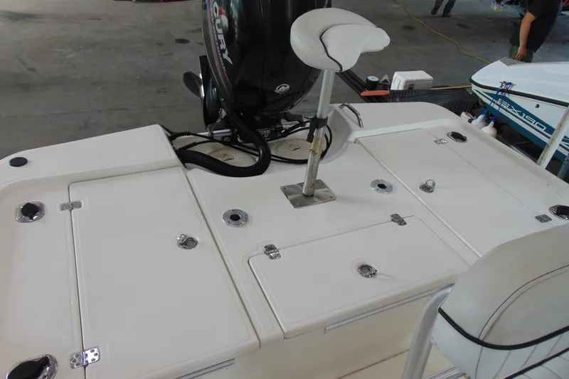 Slide: The Image of 2015 Mako 21 LTS boat deck with storage compartments and seating. - 8