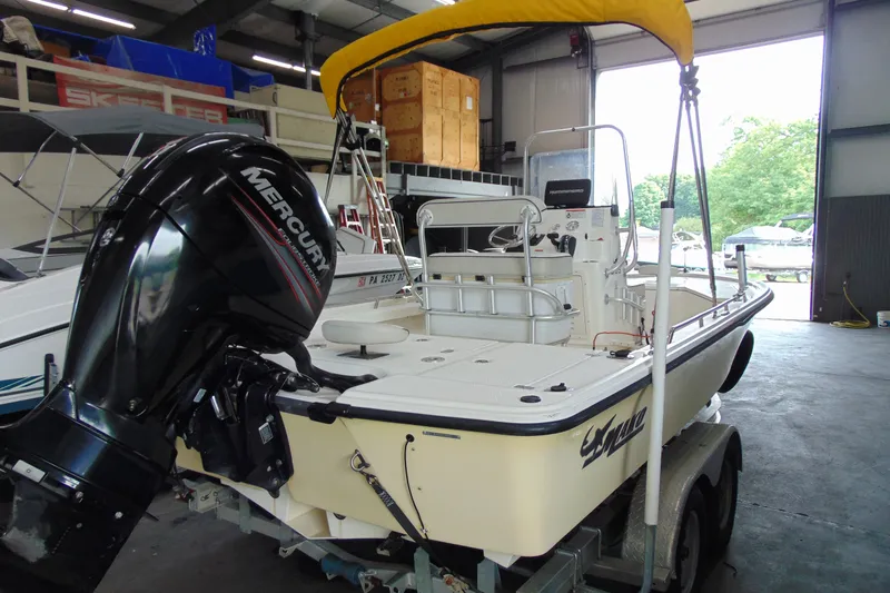 Slide: The Image of 2015 Mako 21 LTS boat with Mercury engine in a storage facility. - 3