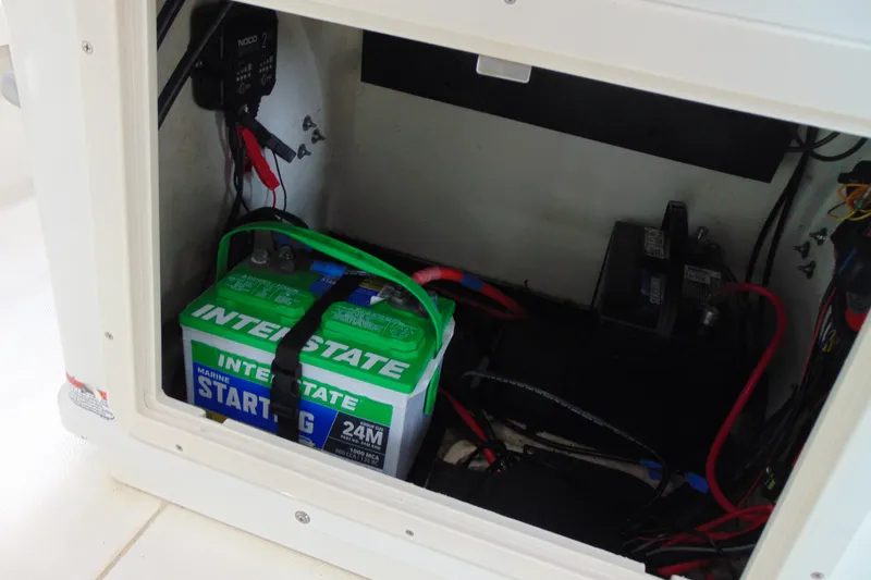 Slide: The Image of Battery compartment of a 2015 Mako 21 LTS boat with Interstate marine battery. - 11