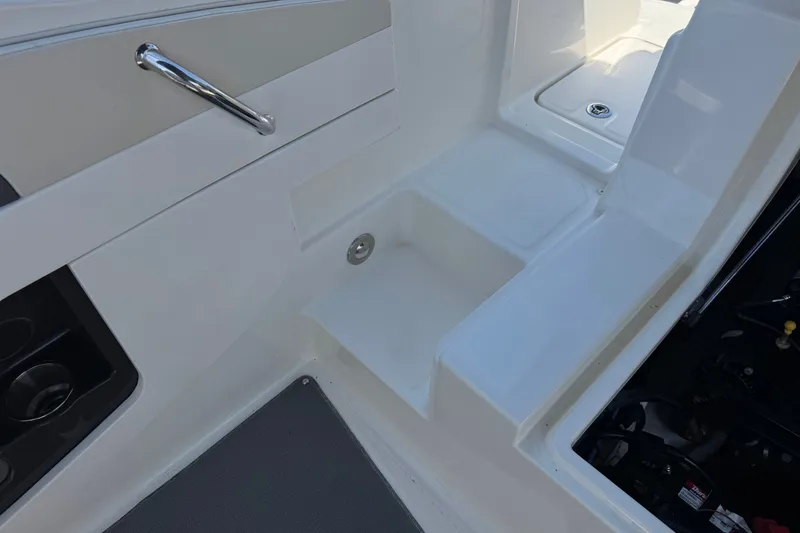 Slide: The Image of Interior view of a 2013 Sea Ray 220 Sundeck boat, featuring seating and storage areas. - 20