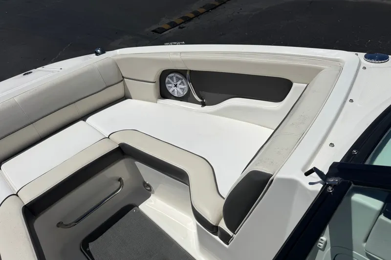 Slide: The Image of 2013 Sea Ray 220 Sundeck boat interior with cushioned seating and speaker. - 15