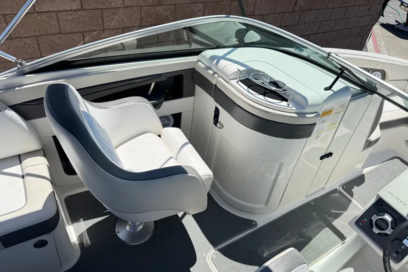 Slide: The Image of 2013 Sea Ray 220 Sundeck interior with helm seat and control panel. - 25