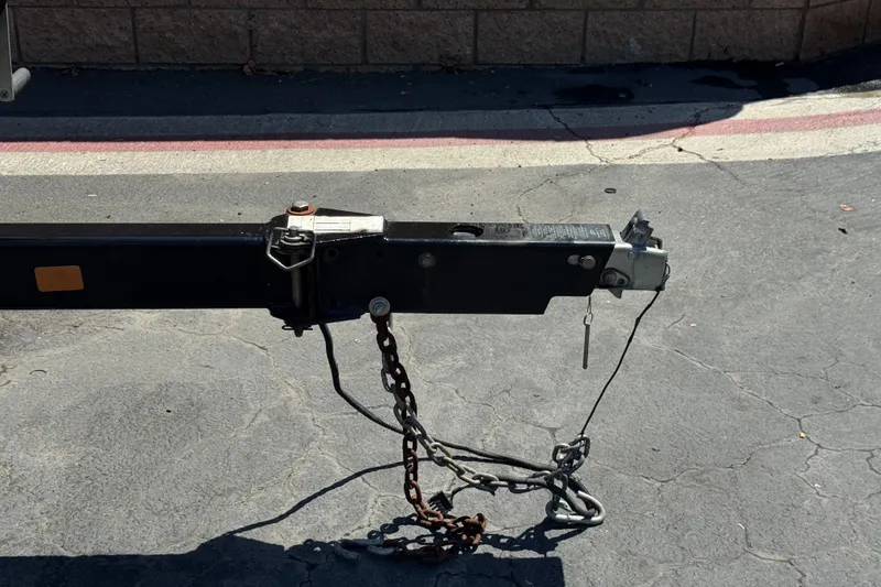 Slide: The Image of Trailer hitch of a 2013 Sea Ray 220 Sundeck on pavement. - 36