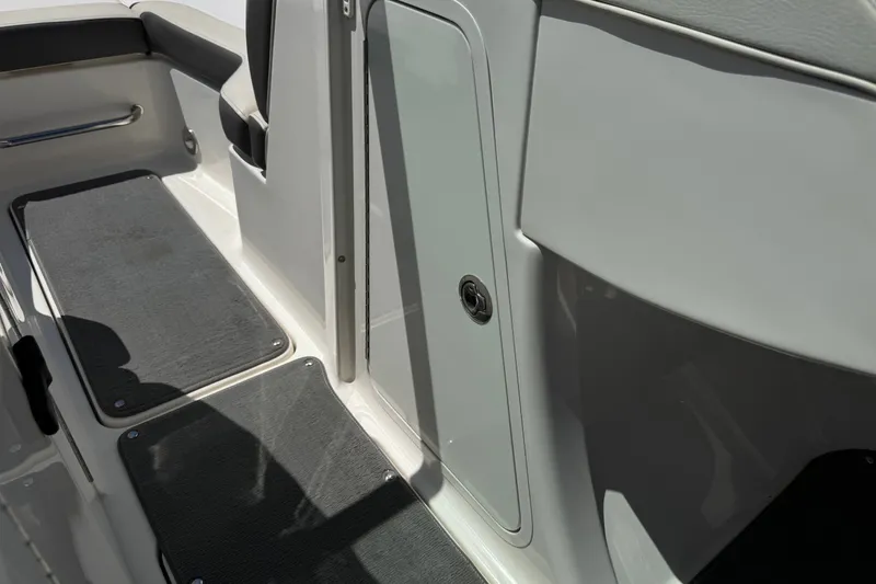 Slide: The Image of Interior view of a 2013 Sea Ray 220 Sundeck boat, featuring seating and storage area. - 33