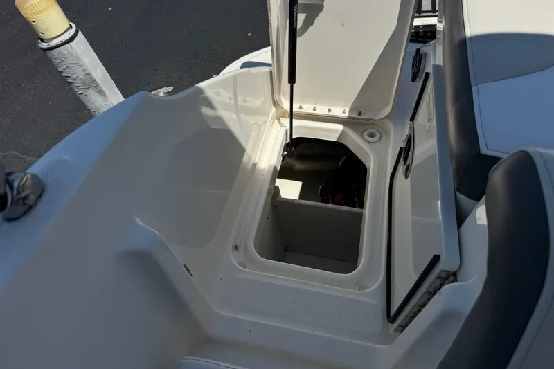 Slide: The Image of Open storage compartment on a 2013 Sea Ray 220 Sundeck boat. - 21