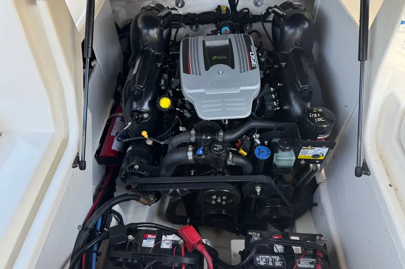 Slide: The Image of Engine compartment of a 2013 Sea Ray 220 Sundeck boat, featuring a MerCruiser engine. - 19