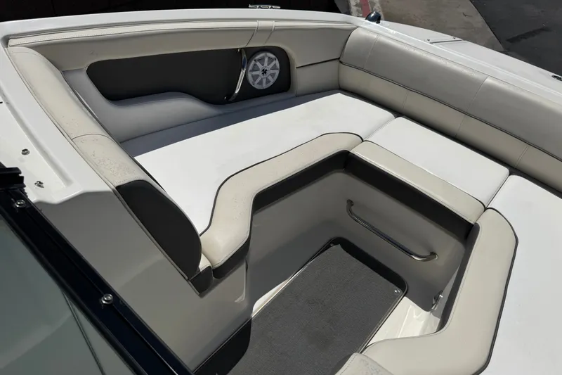 Slide: The Image of 2013 Sea Ray 220 Sundeck interior with white cushioned seating and speaker. - 14