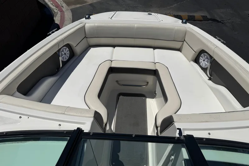 Slide: The Image of 2013 Sea Ray 220 Sundeck boat interior with spacious seating and speakers. - 13