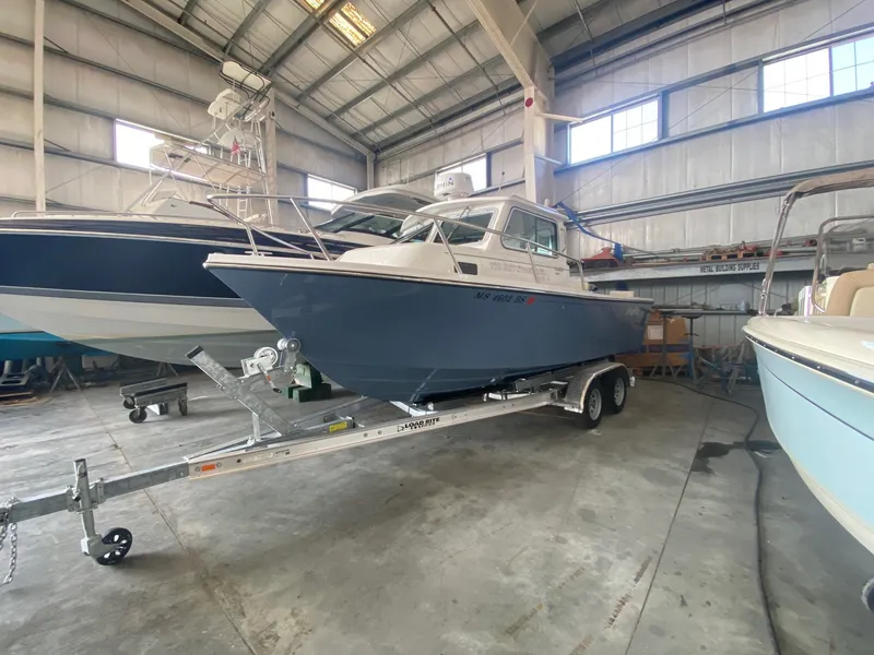 Slide: The Image of Parker 2120 Sport Cabin from 2022 parked on a trailer in a storage facility. - 1