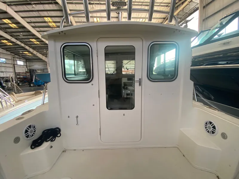 Slide: The Image of The 2022 Parker 2120 Sport Cabin features a sturdy cabin with large windows and a central door. - 9