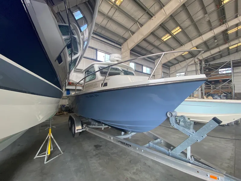 The Image of 2022 Parker 2120 Sport Cabin on a trailer in a storage facility. - 0