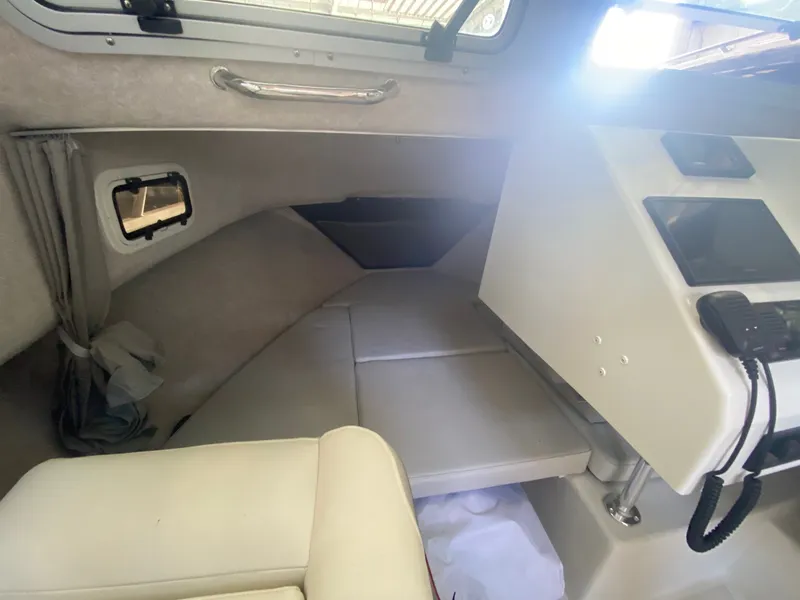 Slide: The Image of Interior of a 2022 Parker 2120 Sport Cabin with seating and helm console. - 7