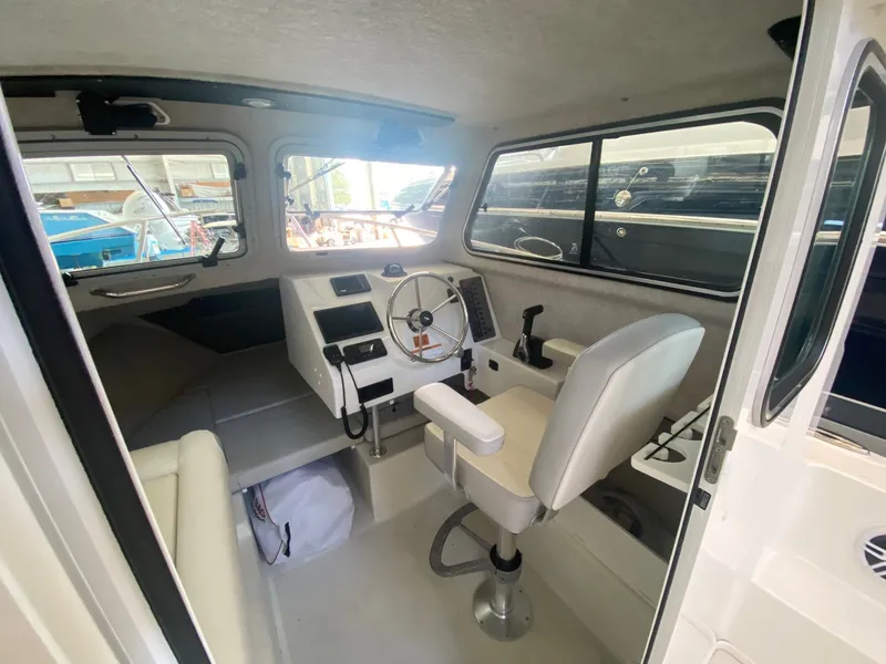 Slide: The Image of Interior of the 2022 Parker 2120 Sport Cabin with helm and seating. - 5