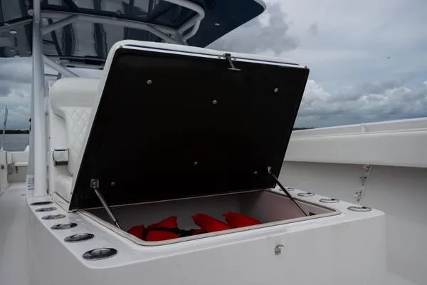 Slide: The Image of Open storage compartment on 2016 SeaHunter 45 Tournament boat with life jackets inside. - 7