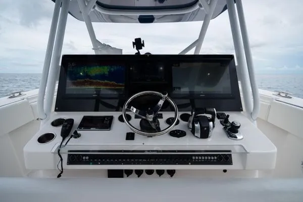 Slide: The Image of Control panel of a 2016 SeaHunter 45 Tournament boat with advanced navigation equipment. - 19