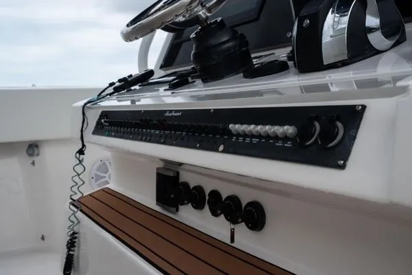 Slide: The Image of Control panel of a 2016 SeaHunter 45 Tournament boat with steering wheel and switches. - 18