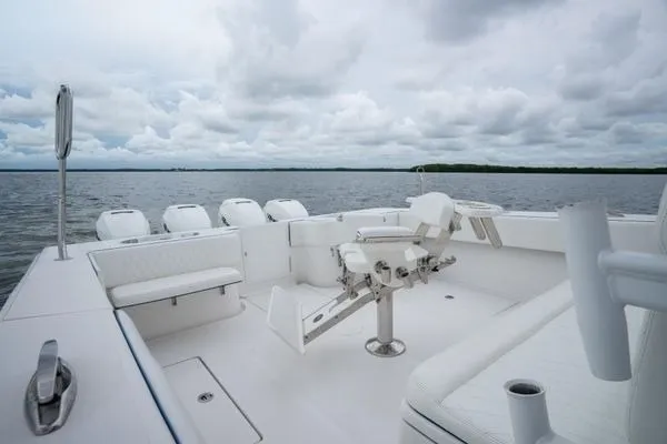 Slide: The Image of 2016 SeaHunter 45 Tournament boat with spacious deck and multiple outboard engines on a cloudy day. - 27