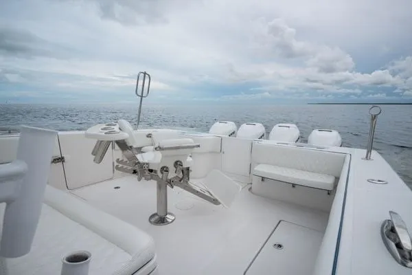 Slide: The Image of 2016 SeaHunter 45 Tournament boat deck with fishing chair, ocean view, and cloudy sky. - 28