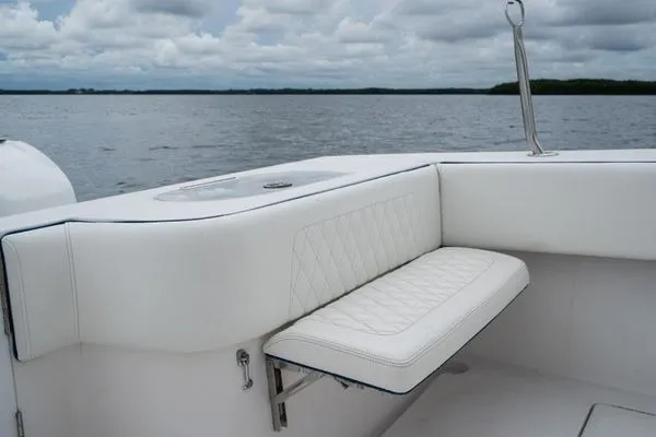 Slide: The Image of 2016 SeaHunter 45 Tournament boat with white cushioned seating, overlooking a calm sea. - 24