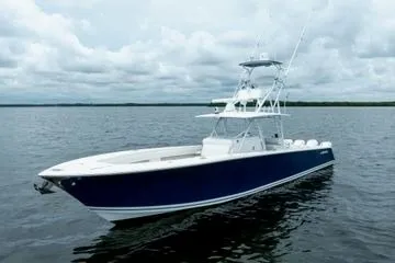 The Image of 2016 SeaHunter 45 Tournament boat on calm water under cloudy sky. - 0