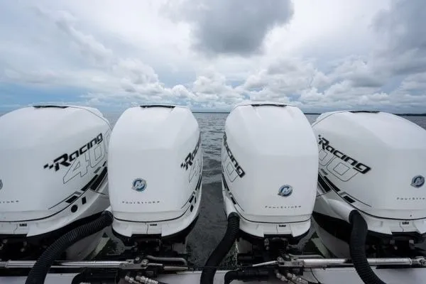 Slide: The Image of Four powerful outboard motors on a 2016 SeaHunter 45 Tournament boat against a cloudy sky. - 25