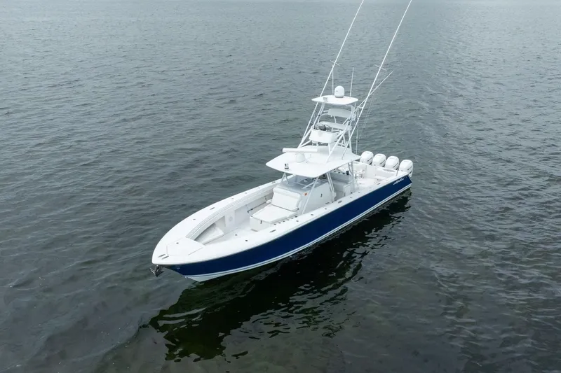 Slide: The Image of 2016 SeaHunter 45 Tournament boat on calm water, featuring sleek design and multiple engines. - 1