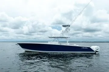 Slide: The Image of 2016 SeaHunter 45 Tournament boat on calm water under cloudy sky. - 38