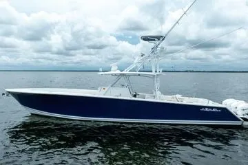 Slide: The Image of 2016 SeaHunter 45 Tournament boat on calm water under cloudy sky. - 2