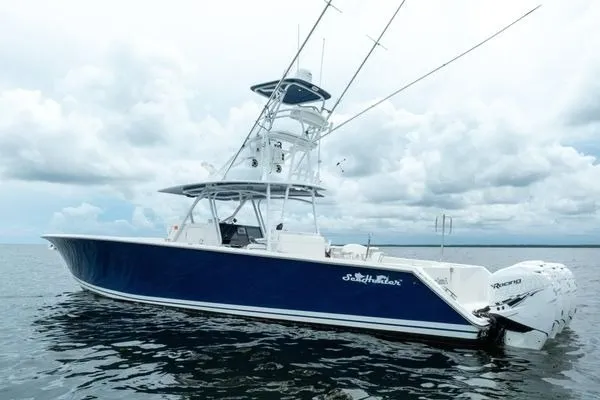 Slide: The Image of 2016 SeaHunter 45 Tournament boat on water, featuring sleek blue design and multiple outboard engines. - 36