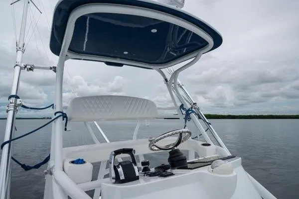 Slide: The Image of 2016 SeaHunter 45 Tournament boat helm with steering wheel and controls on calm water. - 11